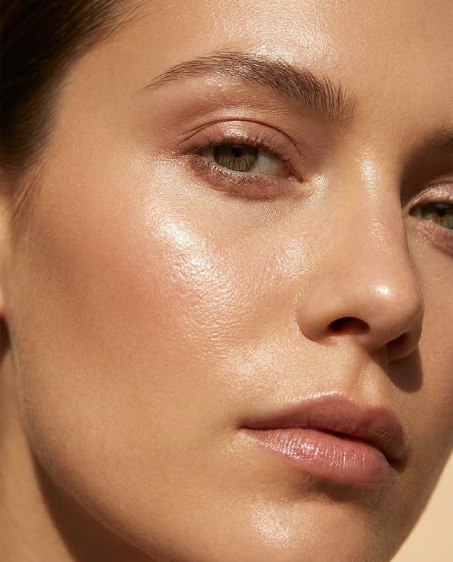 A close-up of smooth, radiant skin in warm light